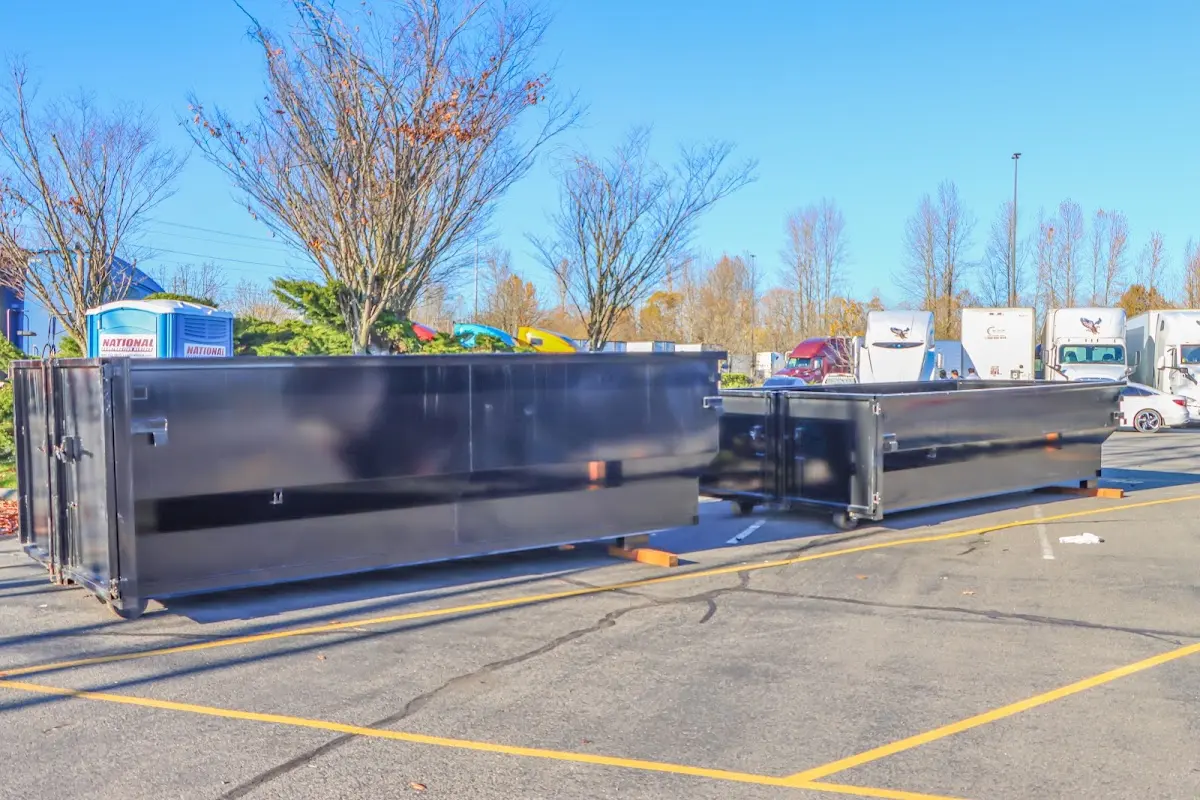 Professional dumpster rental service with roll-off container on residential driveway in Cheshire